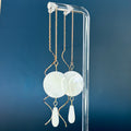 White Mother of Pearl Large Drops with gold-plated threaders and delicate dangling pearl accents on clear display stand