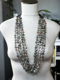 Five Strand Red Abalone Coin Necklace with layered round shell coins on a mannequin bust in natural light