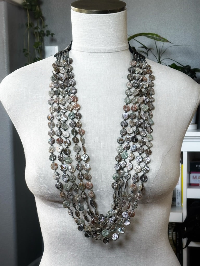 Five Strand Red Abalone Coin Necklace with layered round shell coins on a mannequin bust in natural light