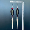 Pinenut Spike Dangles with black pinenuts, deep red beads, and silver spikes on stainless steel ear wires