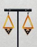 Bronze Triangle Dangles with warm bronze open frames and handmade black and cream beaded geometric triangle patterns