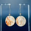 Large Abalone Circle Drops with oversized red iridescent rounds hanging from delicate gold threader chains