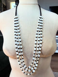 Black and White Shell and Glass Triple Strand Necklace with white shell coins, black beads, and blackened pinenuts, 43-inch length