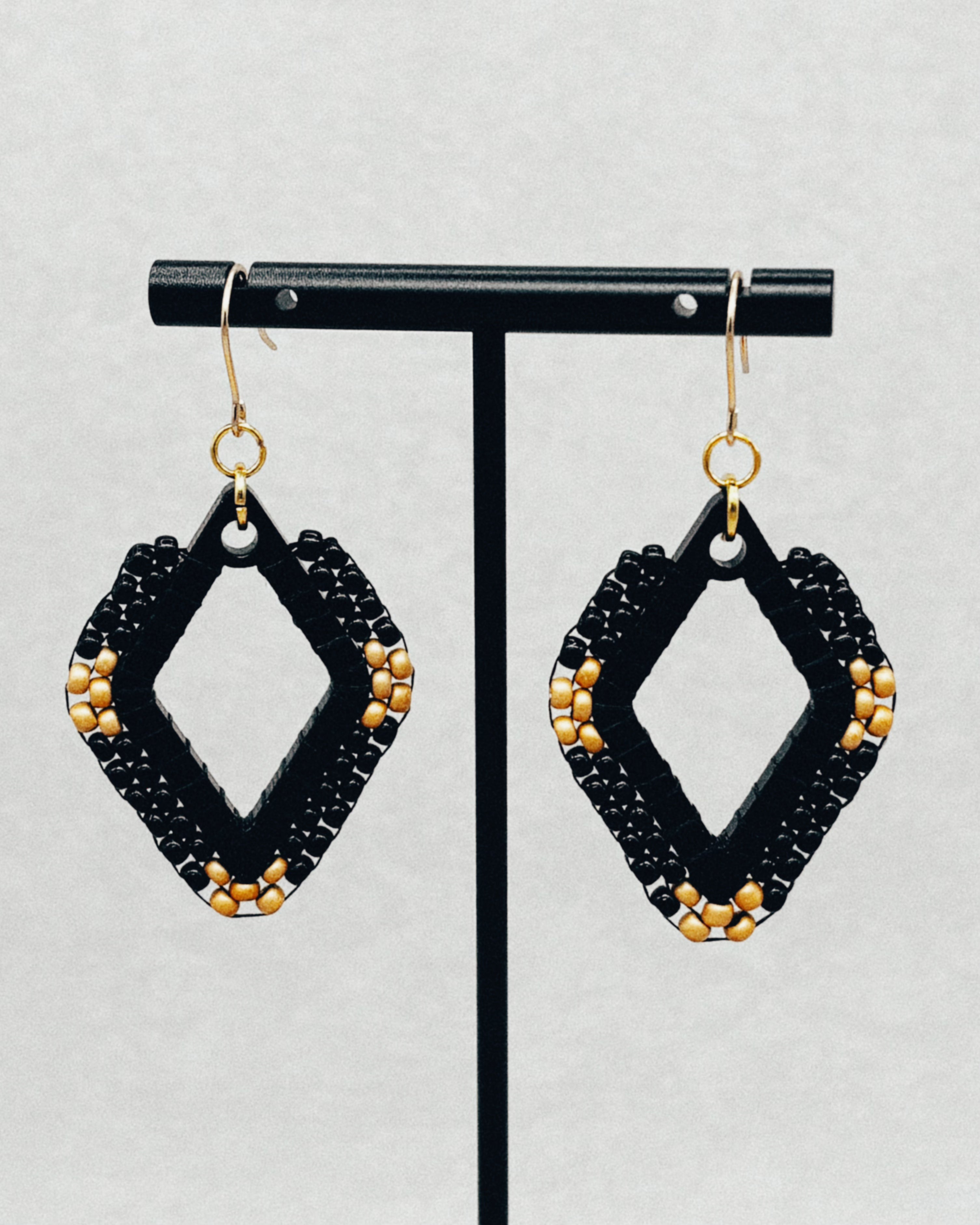 Black Diamond Brick Stitch Diamond Dangles featuring black beads and gold accents on gold hooks with a geometric diamond shape