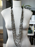 5 Strand Red Abalone Nugget Necklace displayed on a mannequin with natural light and indoor plants in the background