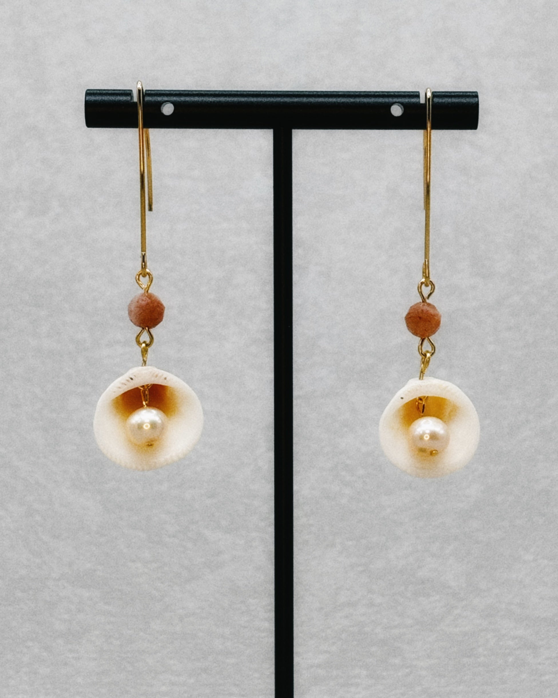 Clam, Pearl, and Sunstone Dangles featuring delicate shells with pearls and warm sunstone beads on gold-tone hooks