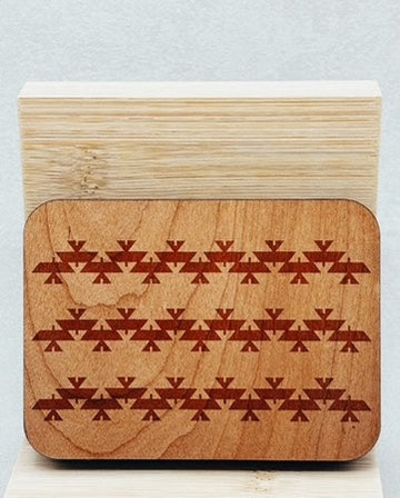 Needle Keepers with engraved wooden surface featuring rows of geometric indigenous-inspired triangular motifs