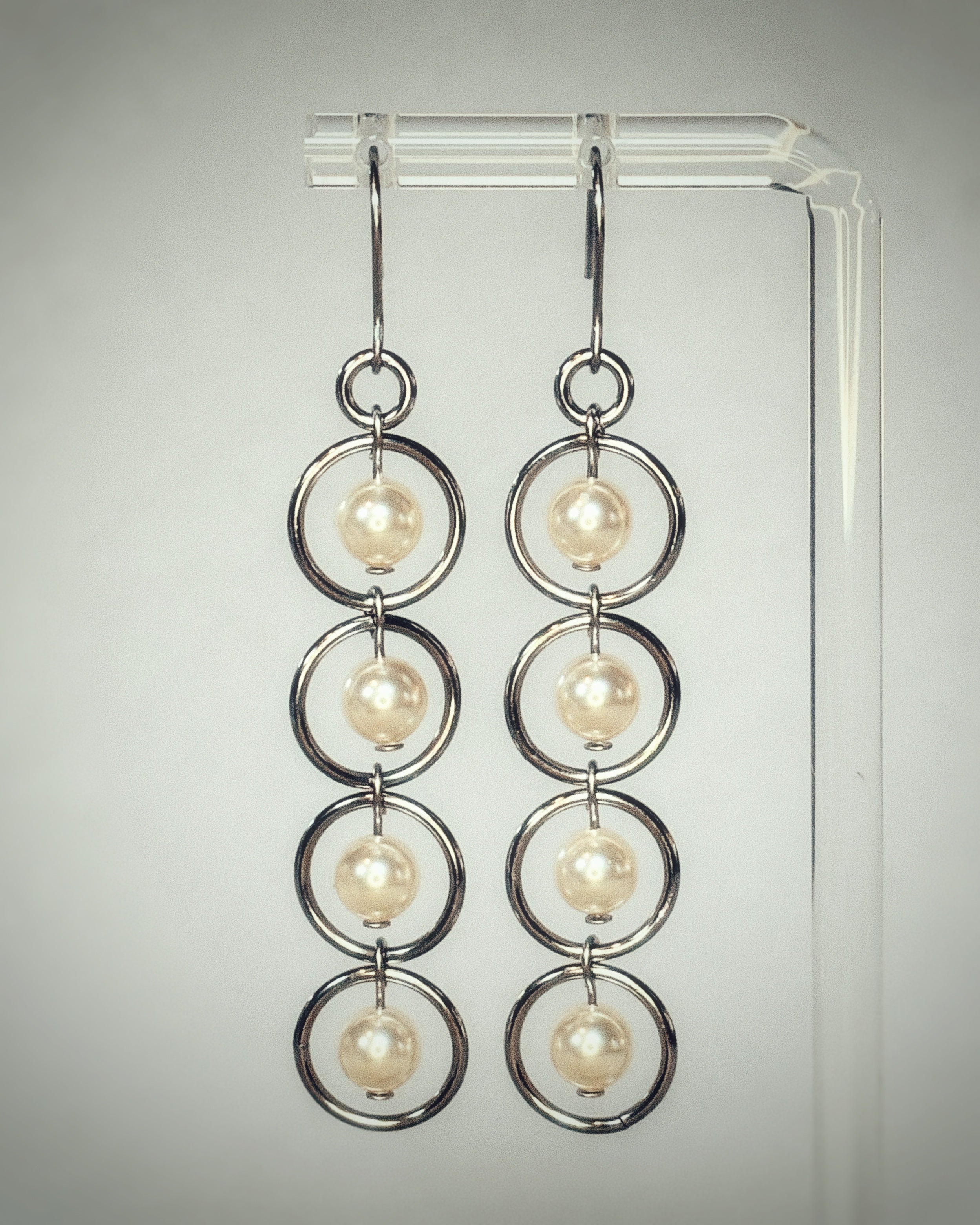 Pearl Silver Dangles with four linked silver rings each holding a round pearl bead, gallery position 1.