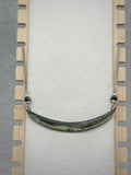 Abalone Lip Necklace featuring a polished shell centerpiece with iridescent green and blue hues on a silver chain