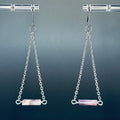 Wampum Chain Drops featuring delicate silver chains and horizontal wampum cylinder beads against dark background