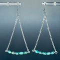Turquoise Silver Chain Drops featuring delicate silver chains and glass turquoise beads in elegant triangular dangle design