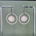 Hammered Silver Rounds with Clamshells earrings featuring delicate natural clamshells suspended in textured silver hoops