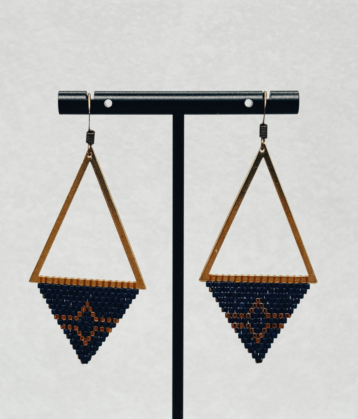 Bronze Triangle Dangles bronze triangular earrings with navy and orange beadwork
