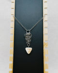 Chainmail Necklace with Shell Triangle featuring silver-tone chainmail links and a polished triangular shell pendant on black background.
