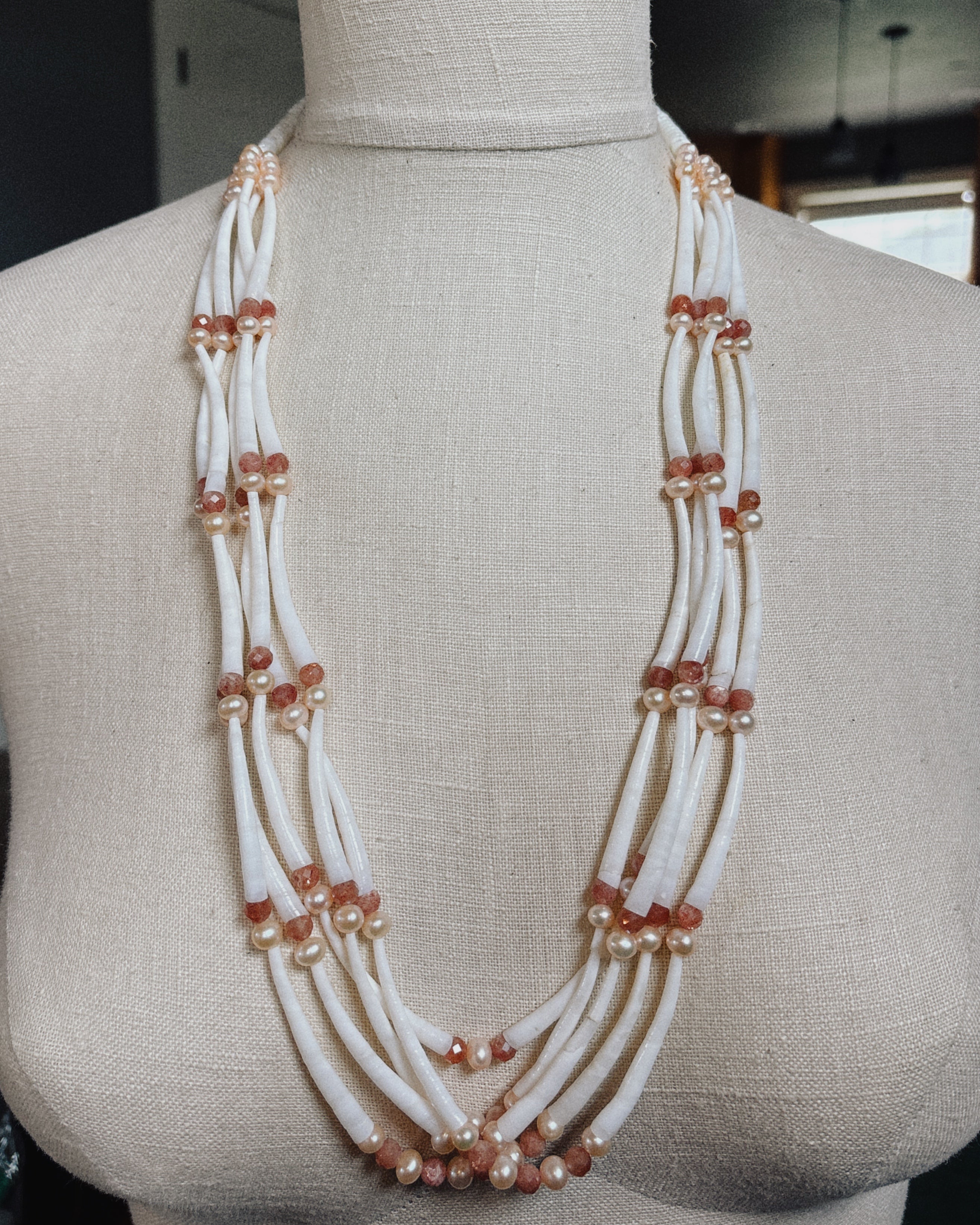 Five Strand Pearl and Sunstone Dentalium Necklace with white elongated beads and warm sunstone accents on layered strands