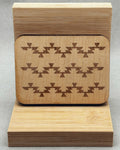Needle Keepers wooden box with engraved dark geometric pattern on smooth light wood surface standing upright
