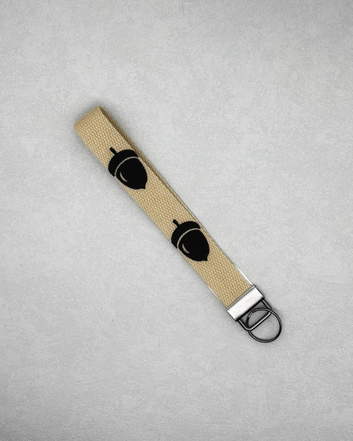 Wristlet Keychains with a beige strap, black bear designs, and a metal key ring