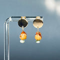 Cedar Berry and Moss Agate Gold Circle Studs with natural cedar berry and green agate stone dangles on clear acrylic stand