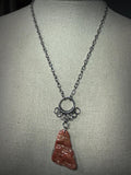 Steel and Abalone Necklace 3 featuring intricate chainmail work with a polished reddish abalone pendant on adjustable steel chain