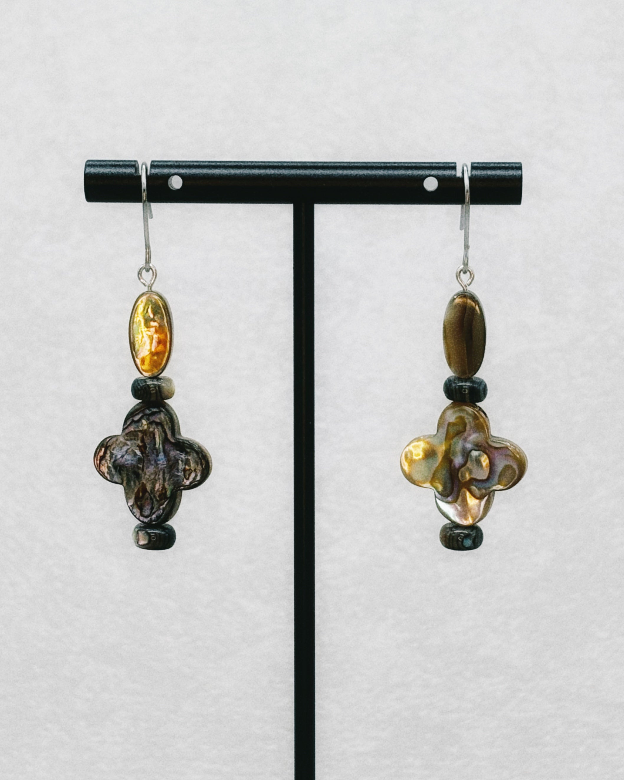 Abalone Quatrefoil Set featuring iridescent quatrefoil shapes and oval beads with dark accent beads on silver hooks