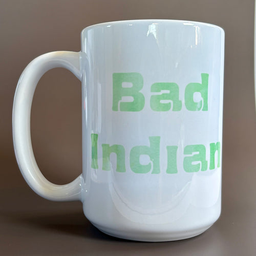 White ceramic 16 oz Bad Indian Mug Green with bold green text showcasing a powerful statement design