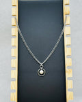 Pearl and Steel Necklace featuring a single pearl pendant set in a circular steel frame on a thick chain