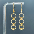 Gold Piercing Dangles featuring three linked rings with chainmail accents, lightweight and elegant 2-inch brass earrings