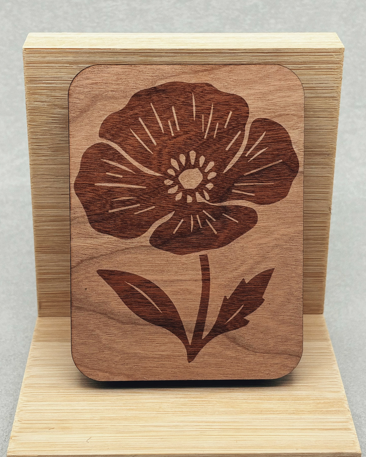Needle Keepers wooden needle holder with a carved floral design and natural wood grain