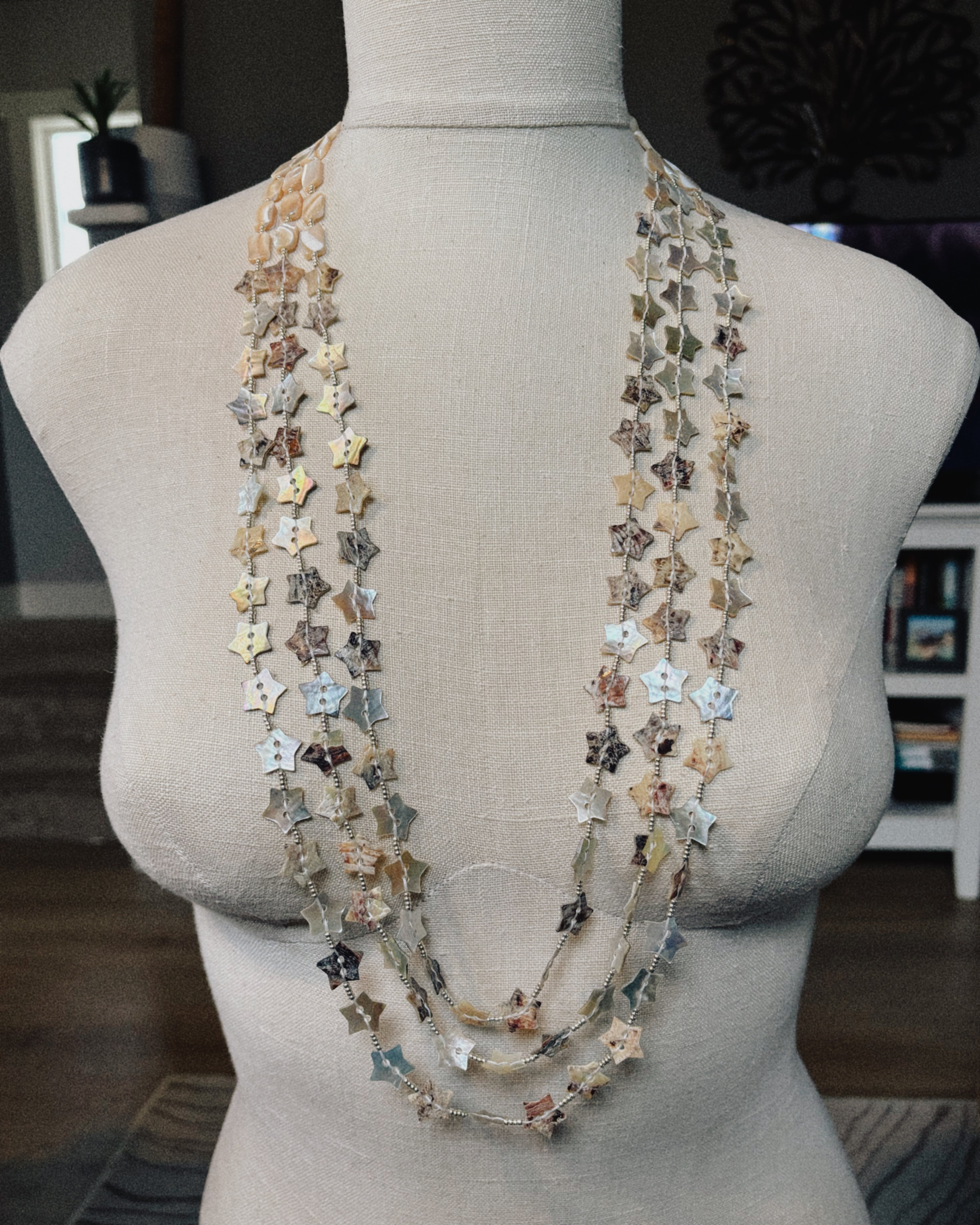 Three Strand Silver Abalone Star Button Necklace with layered star-shaped shell buttons in natural iridescent tones