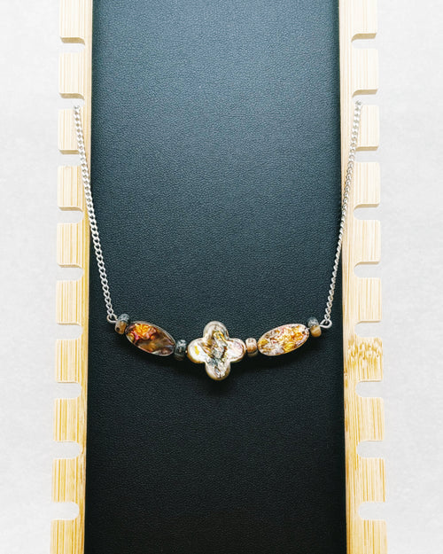Abalone Quatrefoil Set featuring iridescent quatrefoil centerpiece and two amber-toned oval beads on silver chain