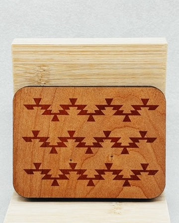 Needle Keepers with warm wooden finish and symmetrical indigenous-inspired triangular pattern engraved on surface