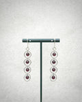 Garnet Silver Circle Dangles featuring four deep red garnet stones set within linked silver rings on hooks