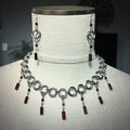 Red and Steel Swirl Set with steel loops and dangling red glass beads on necklace and matching earrings displayed on bust