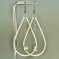 Silver teardrop dangle earrings with hammered finish and iridescent abalone coin accents on delicate chain links