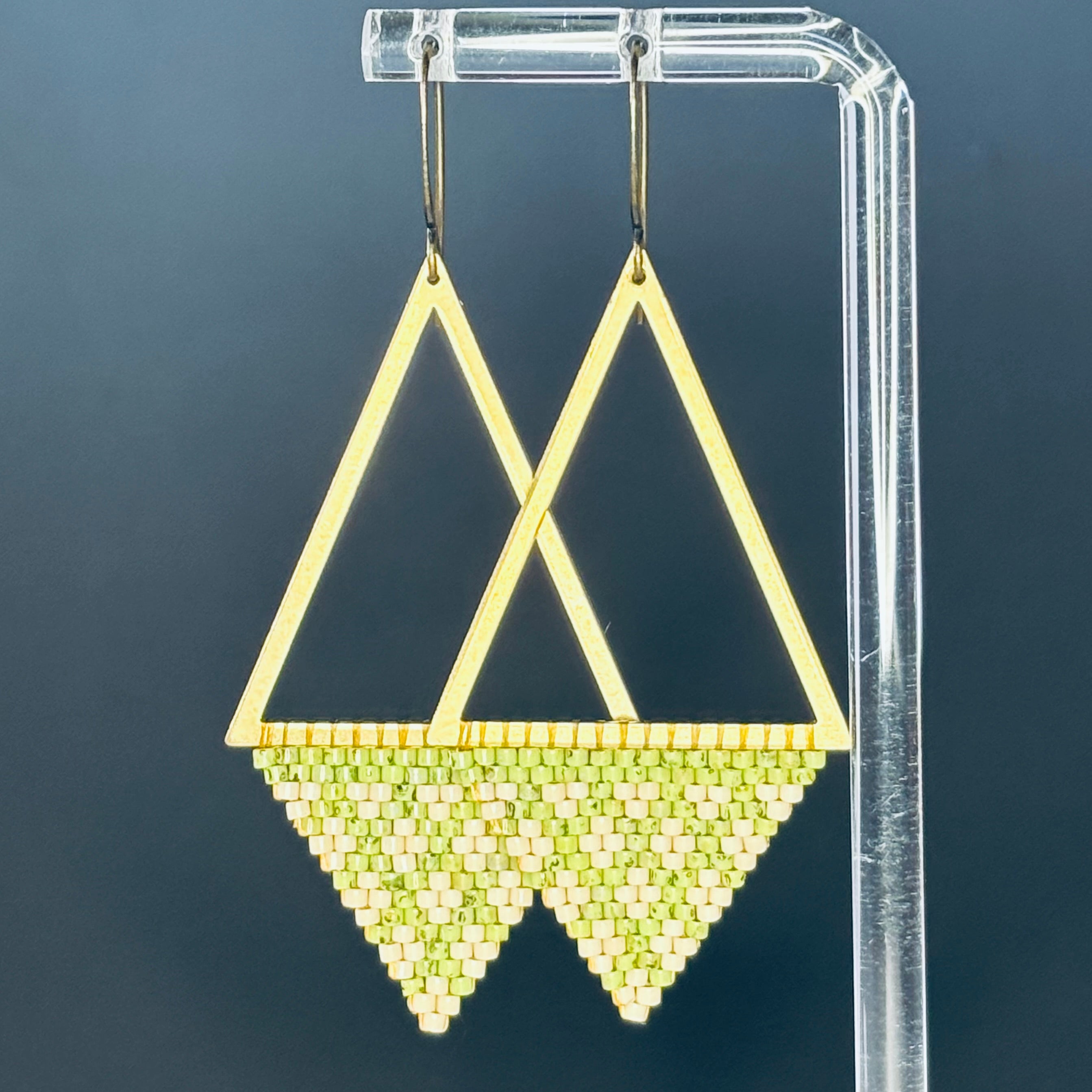Bronze Triangle Dangles with open bronze frames and light green and cream handmade beadwork in geometric patterns