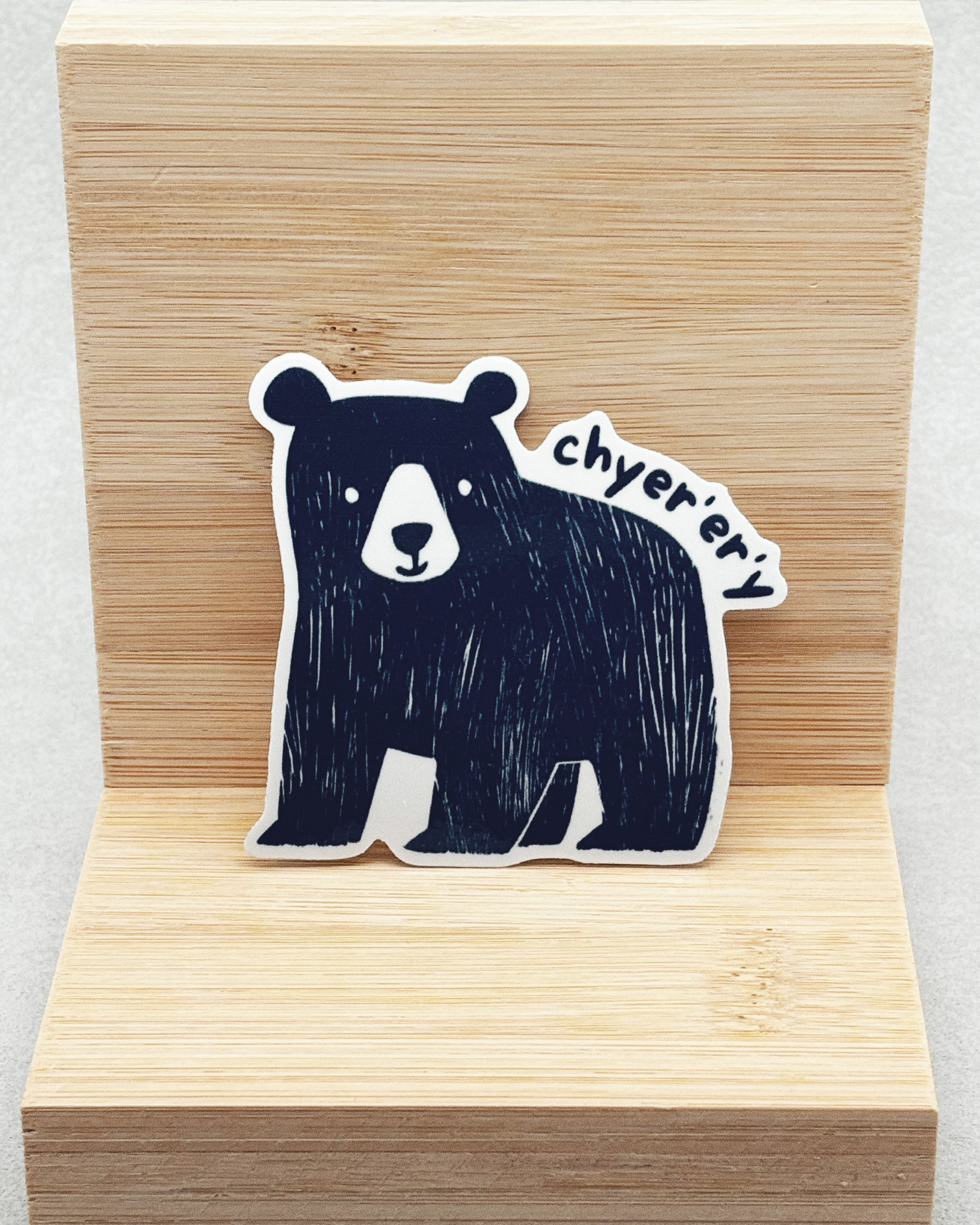 Yurok Vocabulary Stickers showing a hand-drawn black bear with white facial details and the word "chyerery" on light wood background