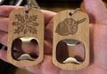 Wooden bottle opener with acorn design held in a hand, blurred background of shelves.