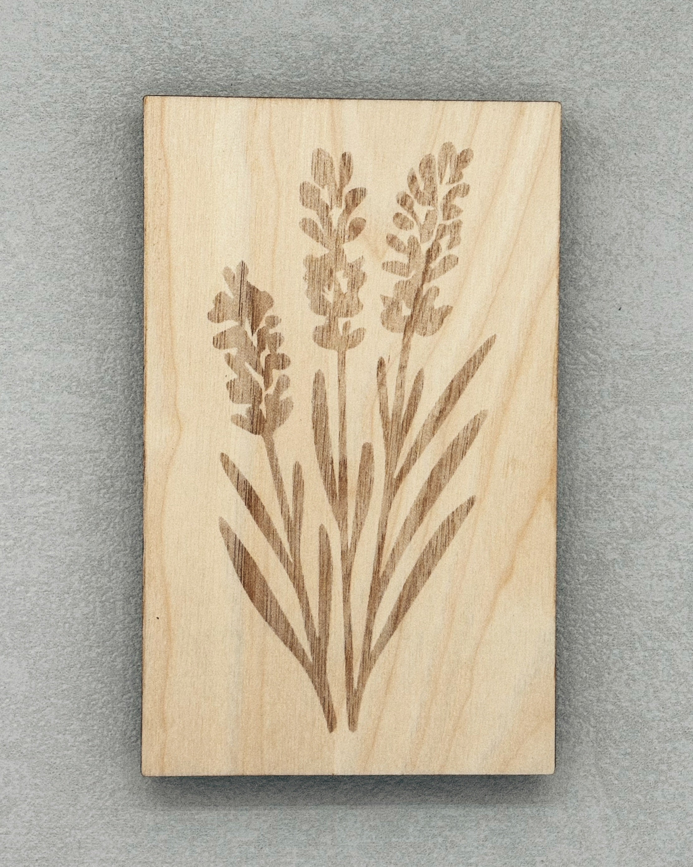 Scissor Keepers wooden piece engraved with a detailed floral design on a gray background