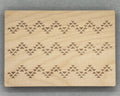 Bigger Bead Board with engraved geometric patterns on a smooth wooden surface for jewelry making.