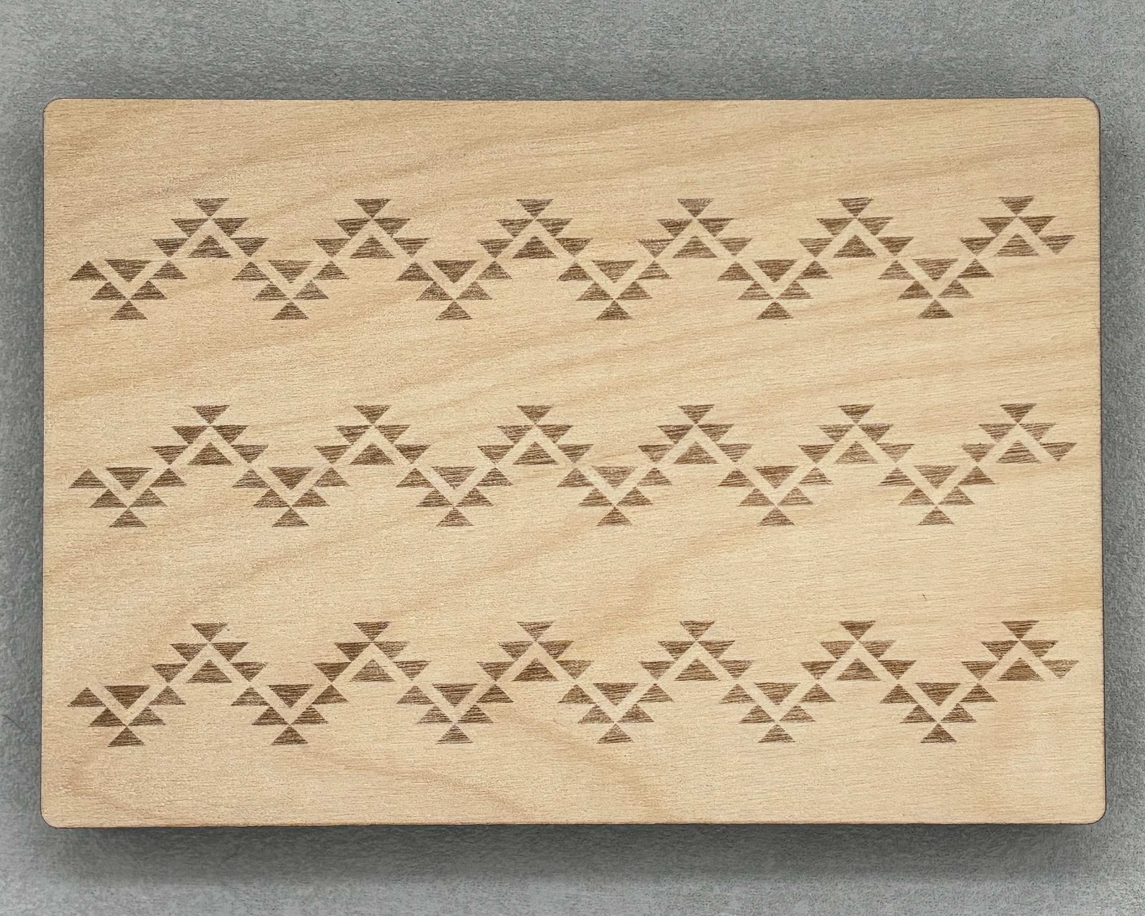 Bigger Bead Board with engraved geometric patterns on a smooth wooden surface for jewelry making.