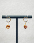Faceted Abalone Gold Open Circle Studs with natural abalone stone drop on gold-tone open circle studs displayed on stand