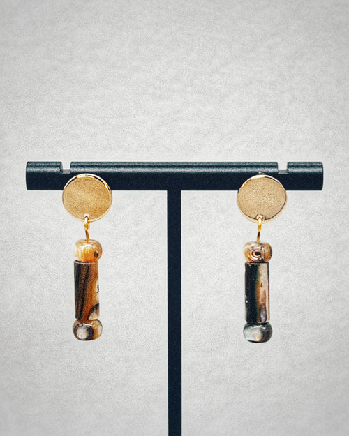 Abalone Cylinder Gold Circle Studs with polished gold discs and natural abalone cylinder drops on a black stand display