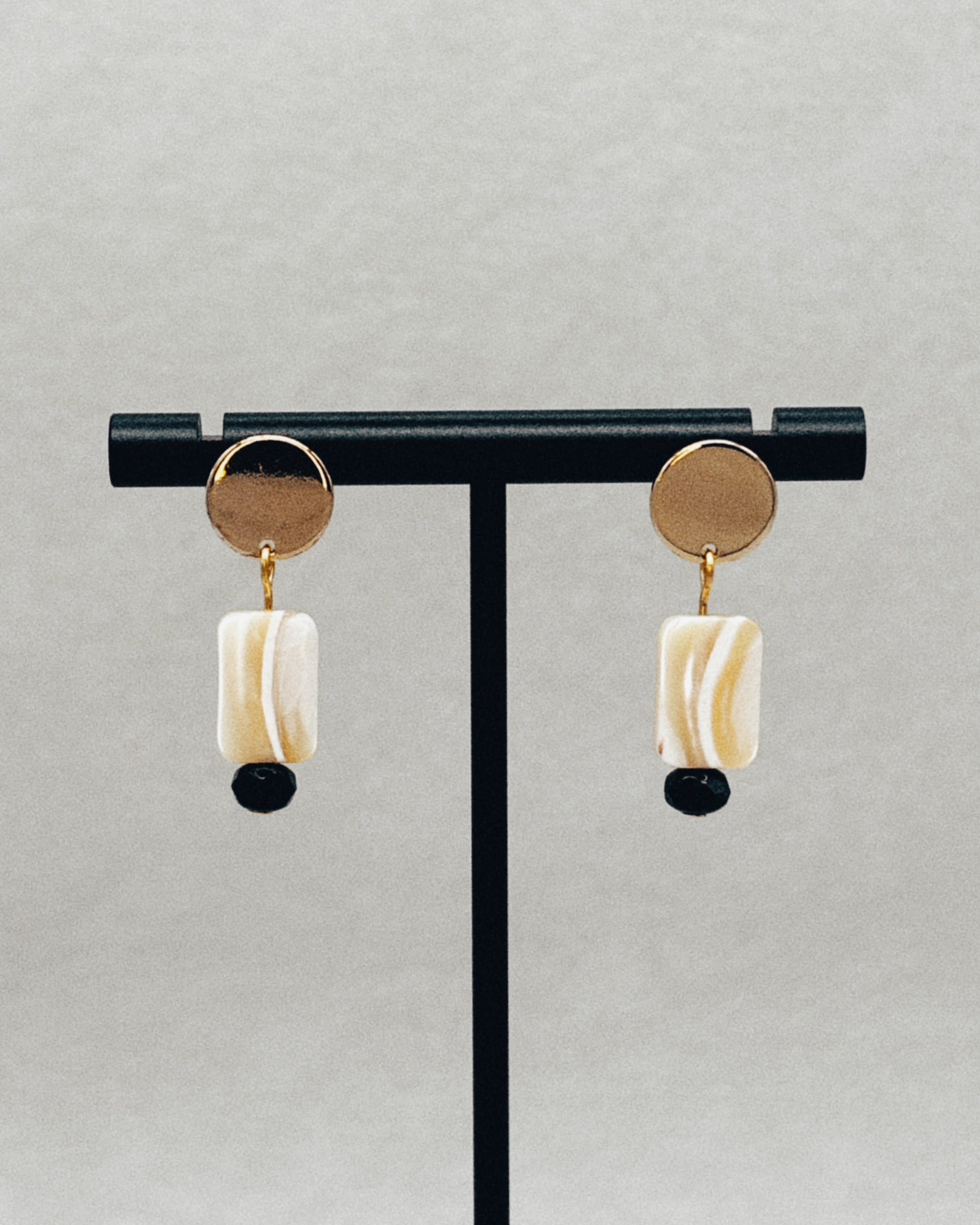 Gold Circle Studs with Shell Rectangles featuring gold round studs and rectangular shell drops with black bead accents
