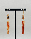 Abalone Rectangle Dangles featuring rectangular abalone pieces with brown bead accents on gold hooks hanging on a black display stand