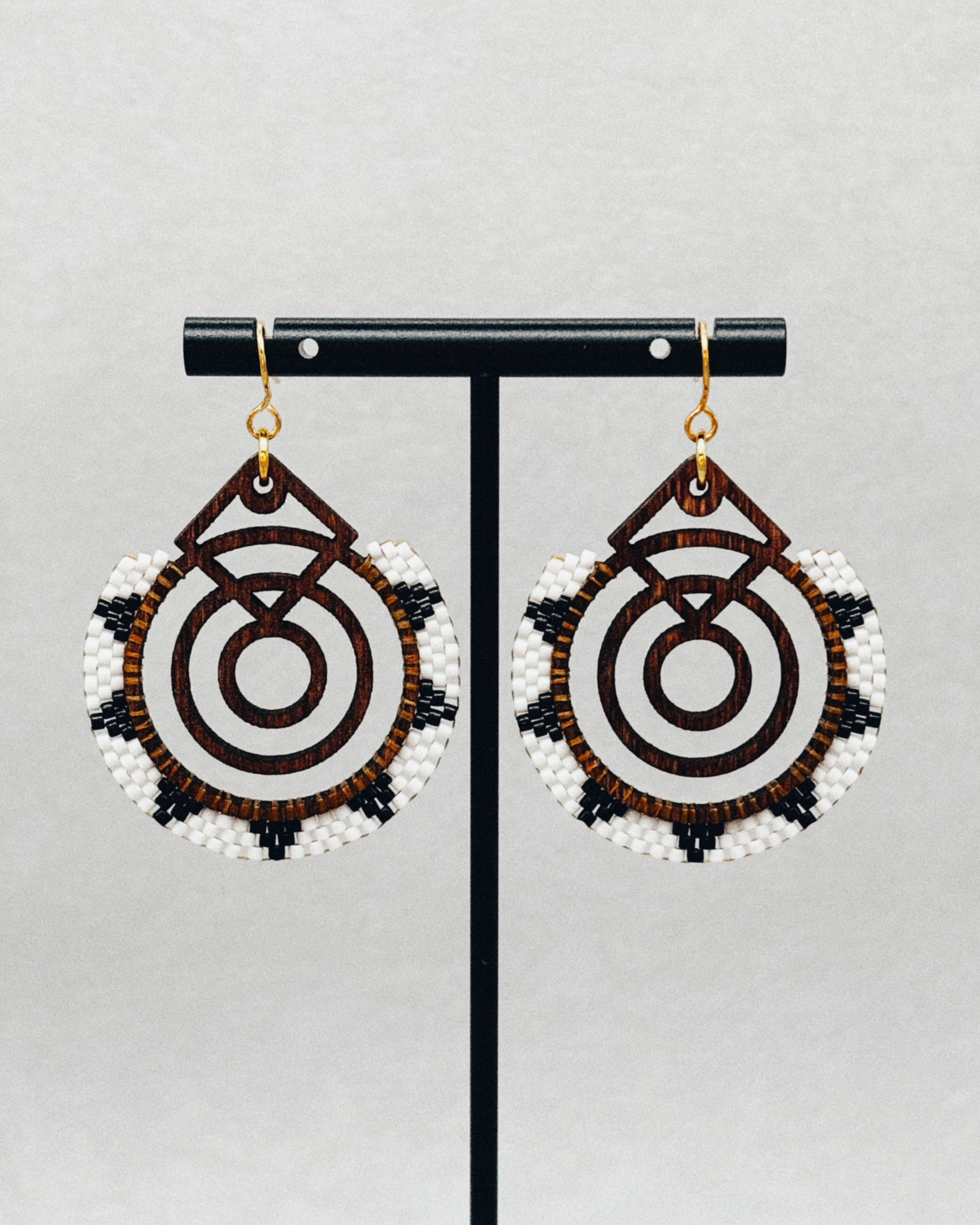 Walnut Brick Stitch Hoop Dangles featuring intricate beadwork with white, black, and brown accents on wooden hoops