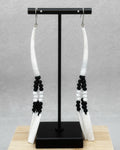 Black and White Dentalium Dangles featuring handmade black and white beads with carved white dentalium shell accents