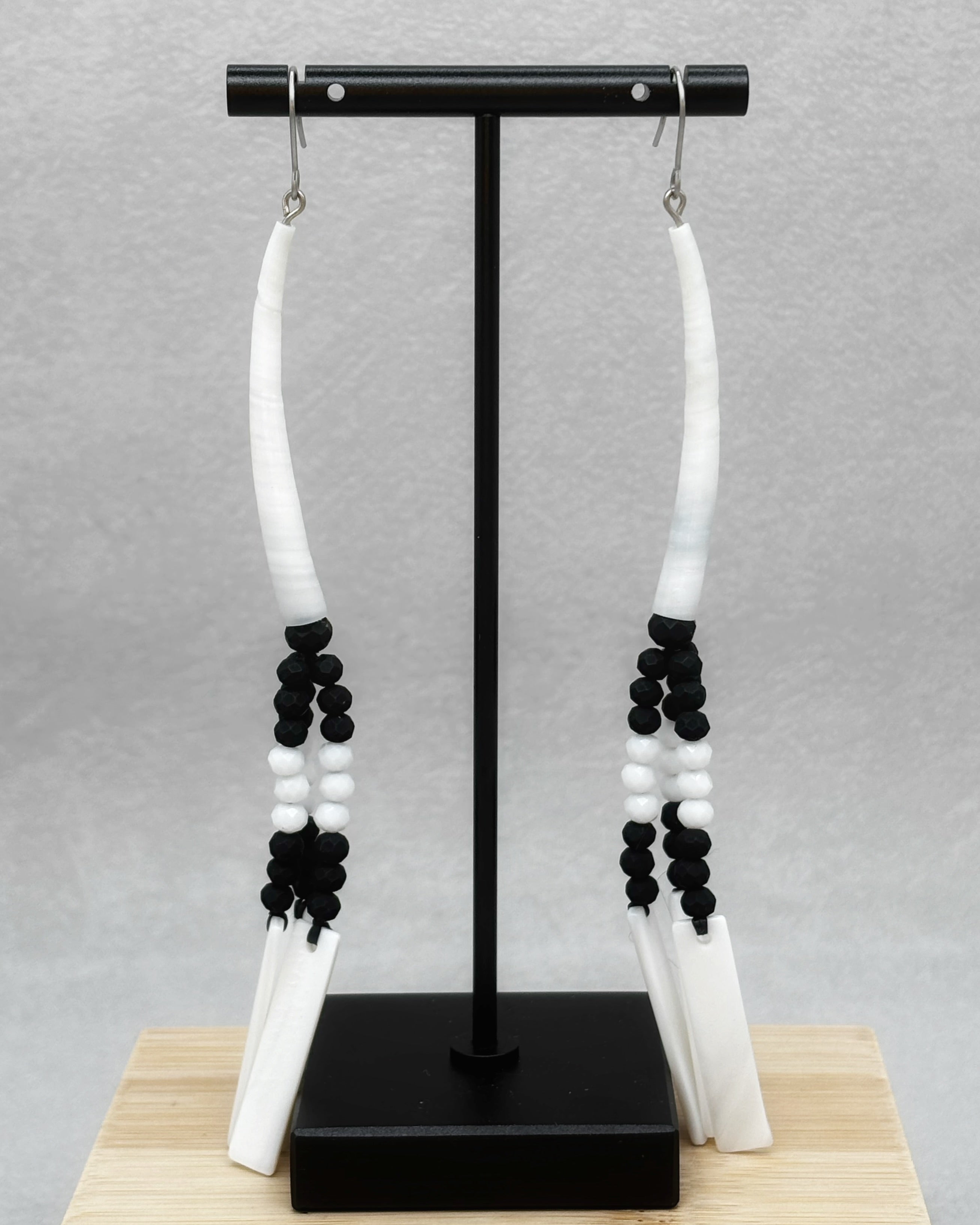Black and White Dentalium Dangles featuring handmade black and white beads with carved white dentalium shell accents
