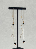 Black and Gold Dentalium Drops hanging delicate gold chains with white dentalium and black bead accents on display stand