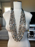 Seven Strand Red Abalone Coin Necklace displayed on a mannequin
